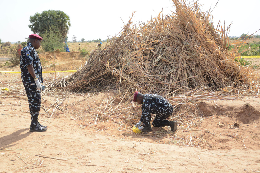 Police Anti-Bomb squad inspect the site of a U.S. airstrike in Northwest, Jabo, Nigeria, Friday, Dec. 26, 2025. (AP Photo/ Tunde Omolehin)