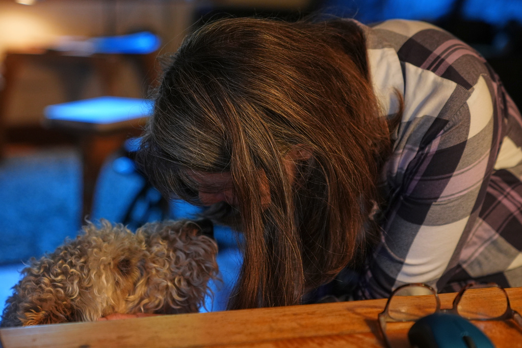 Mary E. Brunkow pets her dog Zelda after winning a Nobel Prize in medicine for part of her work on peripheral immune tolerance, in Seattle, Monday, Oct. 6, 2025. (AP Photo/Lindsey Wasson)