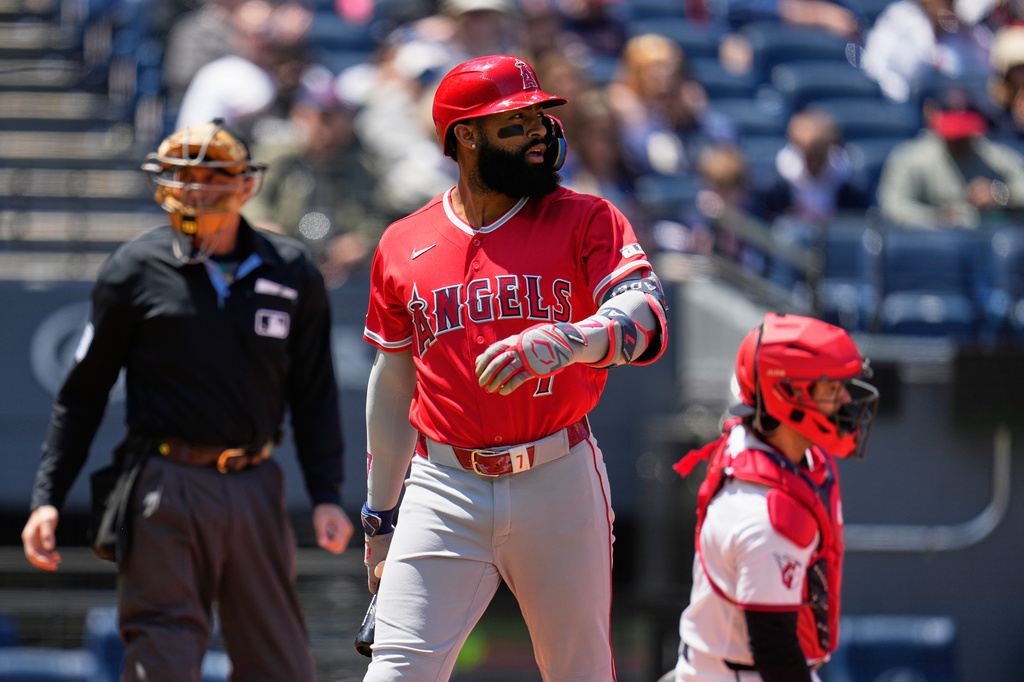 Los Angeles Angels' Jo Adell walks back to the dugout after striking out in the first inning of a baseball game against the Cleveland Guardians in Cleveland, Wednesday, May 13, 2026. (AP Photo/Sue Ogrocki)