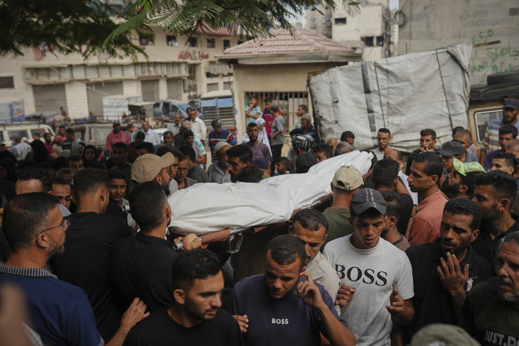 Palestinians carry the body of a person killed in an Israeli army strike, at Shifa Hospital in Gaza City, Thursday, Sept. 4, 2025. (AP Photo/Jehad Alshrafi)