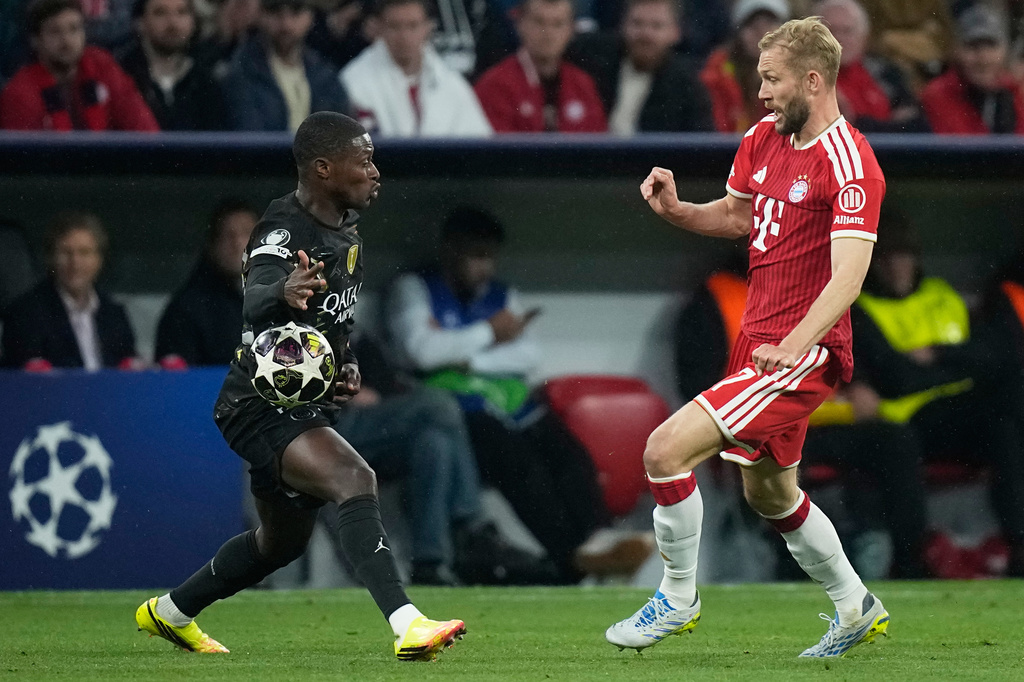 Bayern's Konrad Laimer, right, challenges PSG's Nuno Mendes during the Champions League semifinal second leg soccer match between Bayern Munich and Paris Saint Germain in Munich, Germany, Wednesday, May 6, 2026. (AP Photo/Matthias Schrader)