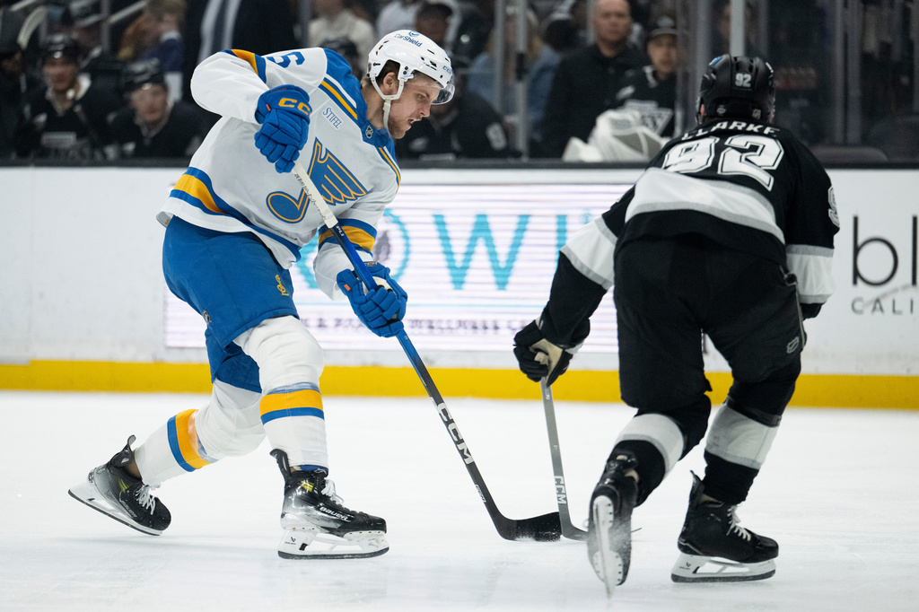 St. Louis Blues defenseman Philip Broberg (6) shoots as Los Angeles Kings defenseman Brandt Clarke (92) defends during the first period of an NHL hockey game, Wednesday, April 1, 2026, in Los Angeles. (AP Photo/Kyusung Gong)