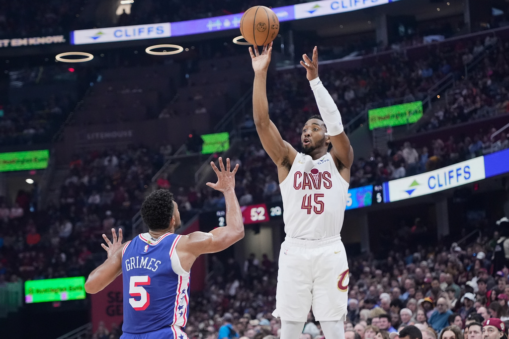 Cleveland Cavaliers guard Donovan Mitchell (45) shoots over Philadelphia 76ers guard Quentin Grimes (5) in the first half of an NBA basketball game in Cleveland, Monday, March 9, 2026. (AP Photo/Sue Ogrocki)