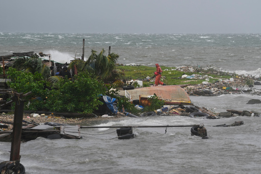 A man walks along the coastline in Kingston, Jamaica, as Hurricane Melissa approaches, Tuesday, Oct. 28, 2025. (AP Photo/Matias Delacroix) A man walks along the coastline in Kingston, Jamaica, as Hurricane Melissa approaches, Tuesday, Oct. 28, 2025. (AP Photo/Matias Delacroix)