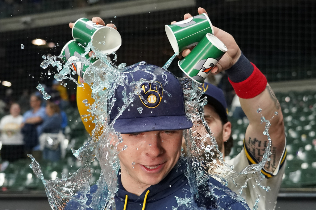 Milwaukee Brewers' Kyle Harrison gets dunked by Garrett Mitchell after a baseball game against the San Francisco Giants, Tuesday, June 2, 2026, in Milwaukee. (AP Photo/Aaron Gash)