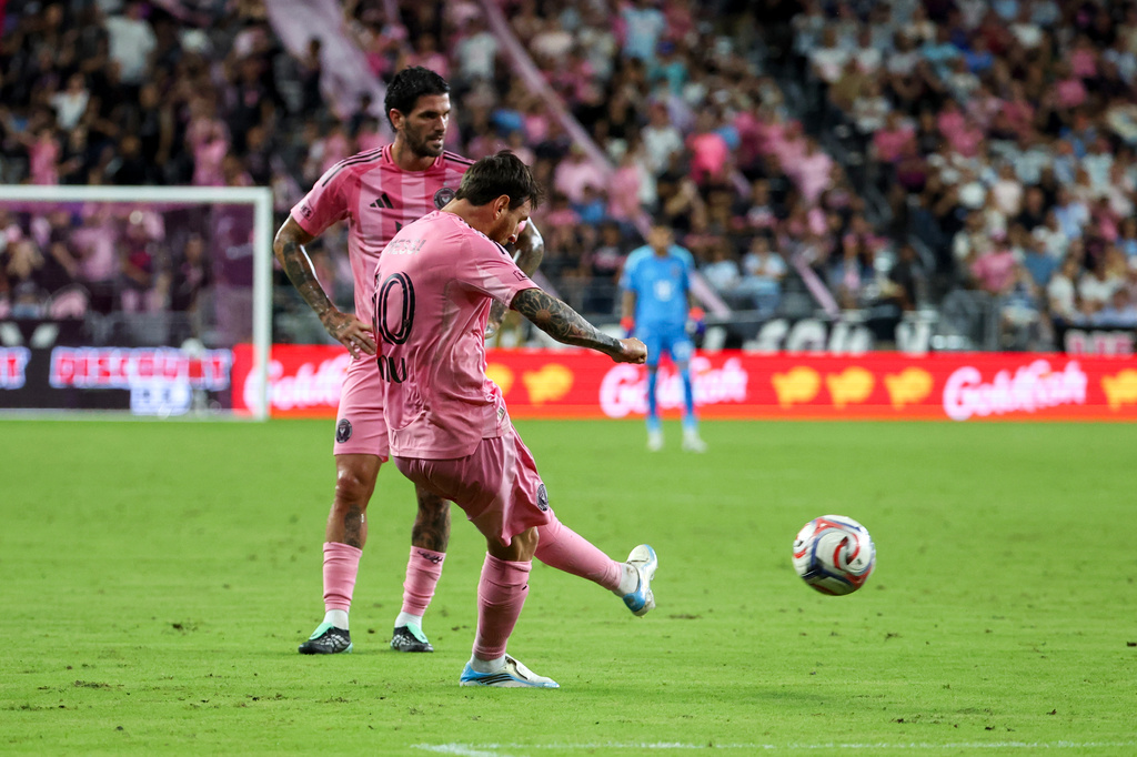 Inter Miami midfielder Rodrigo De Paul, back left, looks on as forward Lionel Messi, front left, shoots and scores on a free kick during the first half of an MLS soccer game against San Diego FC, Sunday, Sept. 20, 2026, in Miami. (AP Photo/David Santiago)