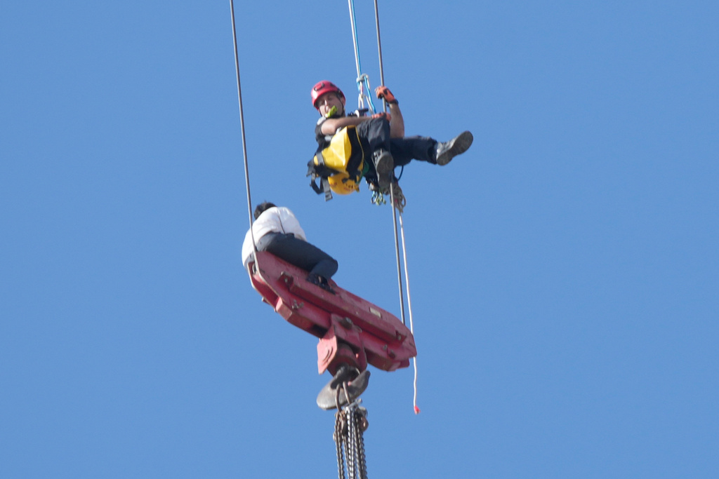 A teenager is rescued from a crane platform atop a skyscraper, where he dangled 36 stories up in the air for seven hours, in Jerusalem Monday, Nov. 24, 2025. (AP Photo/Ohad Zwigenberg)