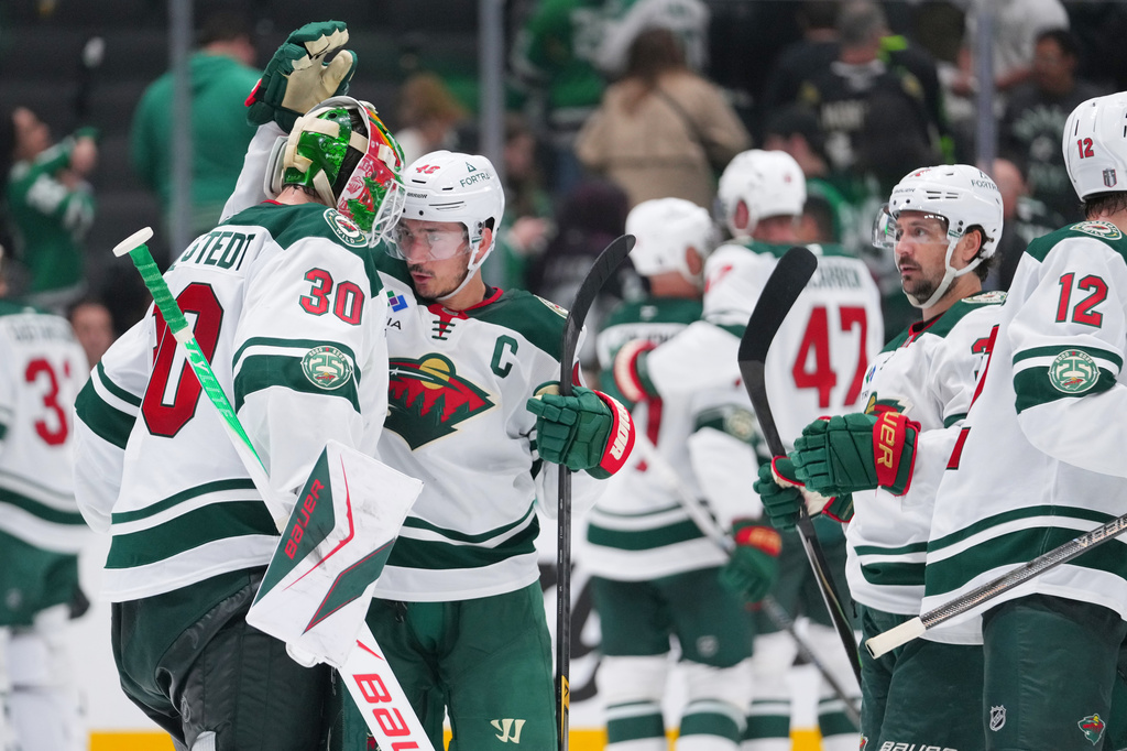 Minnesota Wild goaltender Jesper Wallstedt (30) reacts with defenseman Jared Spurgeon (46) after their team defeated the Dallas Stars 4-2 in Game 5 of a first-round NHL Stanley Cup playoffs hockey series, Tuesday, April 28, 2026, in Dallas. (AP Photo/Julio Cortez)