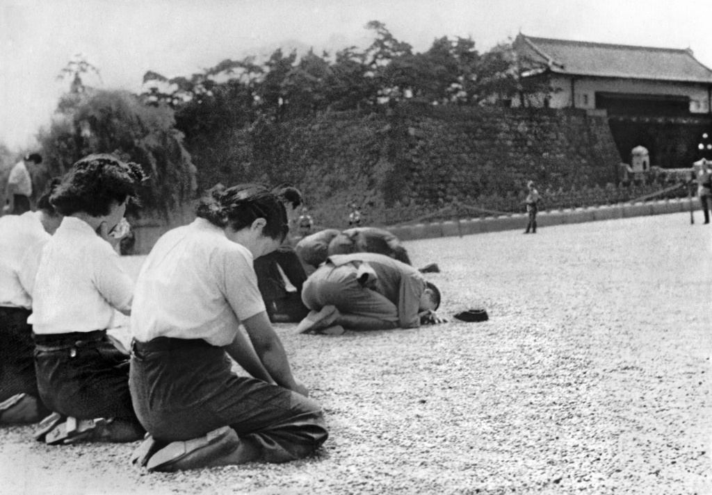 People kneel in front of the Imperial Palace in Tokyo on Aug. 15, 1945, upon learning of the war's end from Emperor Hirohito's "Jewel Voice Broadcast." (Kyodo News via AP)
