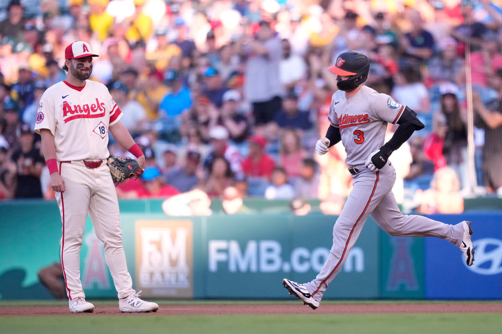 Baltimore Orioles' Taylor Ward, right, heads to second after hitting a solo home run as Los Angeles Angels first baseman Nolan Schanuel watches during the first inning of a baseball game Monday, June 22, 2026, in Anaheim, Calif. (AP Photo/Mark J. Terrill)