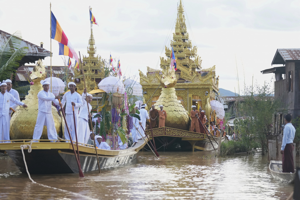 Barges carrying Buddha statues float during the Phaung Daw Oo pagoda festival in Inle Lake, southern Shan State, Myanmar, Tuesday, Sept. 23, 2025. (AP Photo/Thein Zaw)