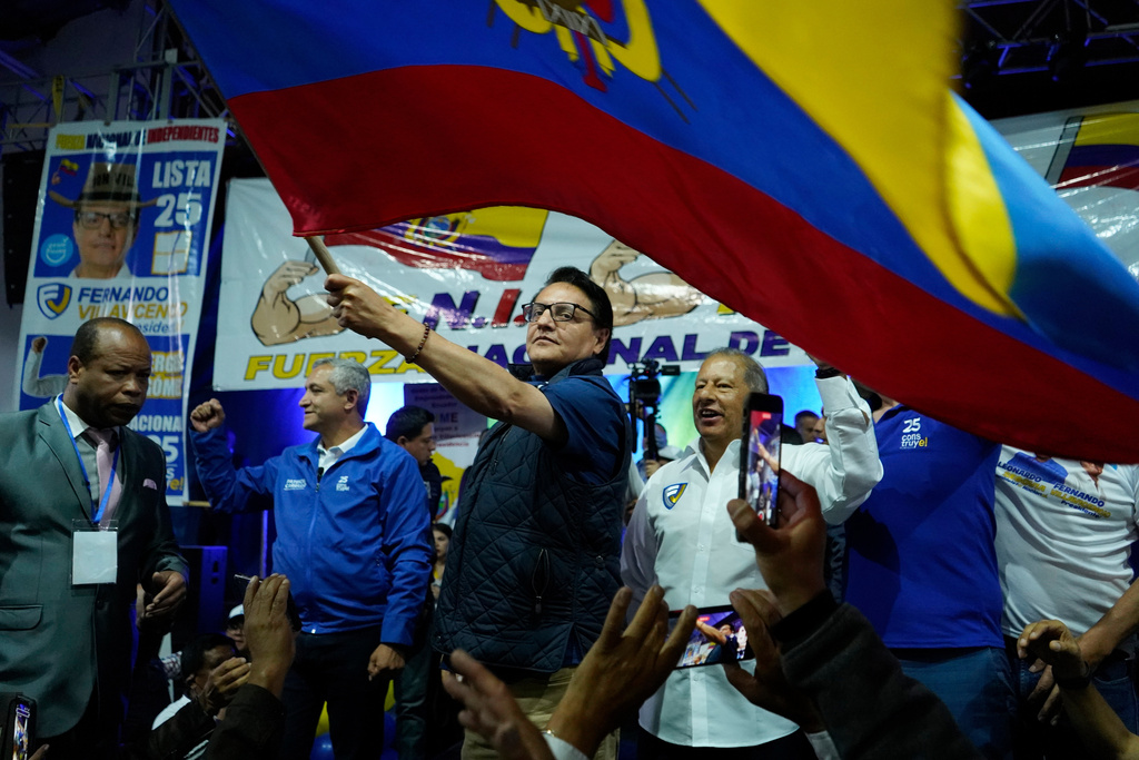 FILE - Presidential candidate Fernando Villavicencio waves an Ecuadorean flag during a campaign event at a school minutes before he was shot to death, in Quito, Ecuador, Aug. 9, 2023. (API via AP File)