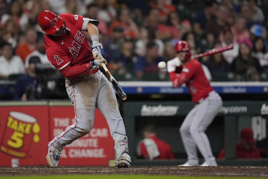 Los Angeles Angels designated hitter Mike Trout, left, doubles during the eighth inning of a baseball game against the Houston Astros in Houston, Sunday, Aug. 31, 2025. (AP Photo/Ashley Landis)