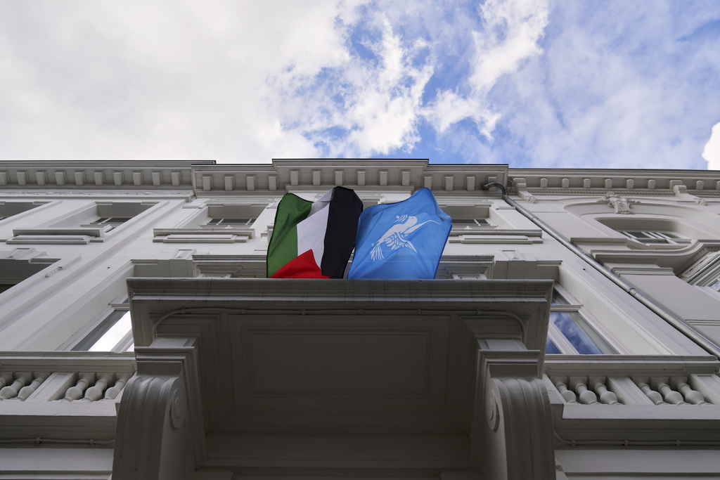 A Palestinian and World Peace flag flap in the wind as they are displayed from a balcony of a house in Antwerp, Belgium, Tuesday, Sept. 2, 2025. (AP Photo/Virginia Mayo)