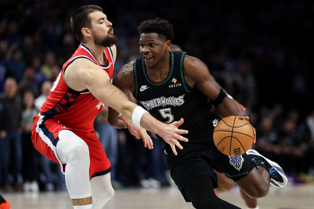 Minnesota Timberwolves guard Anthony Edwards, right, works around Los Angeles Clippers center Ivica Zubac (40) during the first half of an NBA basketball game Saturday, Dec. 6, 2025, in Minneapolis. (AP Photo/Matt Krohn)