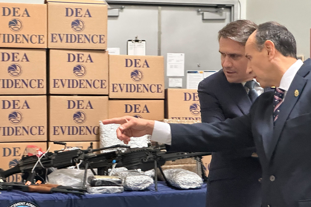 Acting Attorney General Todd Blanche looks at weapons and drugs that were seized by federal officers, with Drug Enforcement Administration special agent in charge Apolonio Ruiz, Jr., at a warehouse in Phoenix, Wednesday, May 6, 2026. (AP PhotoRebecca Santana)