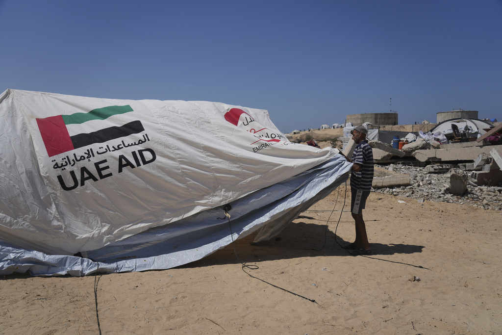 Ne'man Abu Jarad, 50, sets up his family's tent in Khan Younis, Gaza Strip, following their displacement from Gaza City, Sept. 11, 2025. (AP Photo/Abdel Kareem Hana)