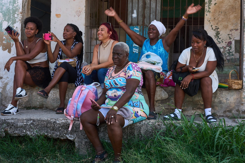Residents watch an outdoor performance of young dancers led by choreographer Juan Miguel Mas, in a neighborhood of Havana, Cuba, Saturday, May 9, 2026. (AP Photo/Ramon Espinosa)