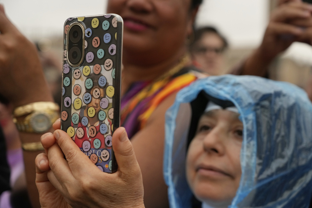 A faithful takes pictures with a mobile phone during the weekly general audience with Pope Leo XIV in St. Peter's Square, at the Vatican, Wednesday, Sept. 10, 2025. (AP Photo/Gregorio Borgia)