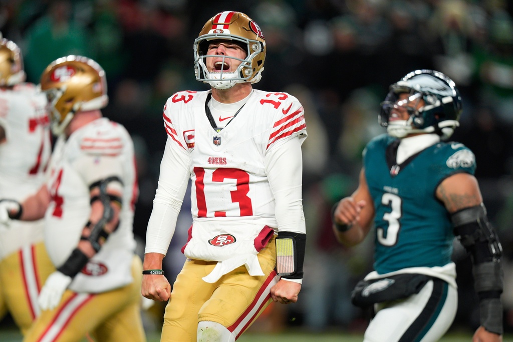 San Francisco 49ers quarterback Brock Purdy (13) reacts to a touchdown pass to 49ers running back Christian McCaffrey during the second half of an NFL wild-card playoff football game against the Philadelphia Eagles on Sunday, Jan. 11, 2026, in Philadelphia. (AP Photo/Chris Szagola)