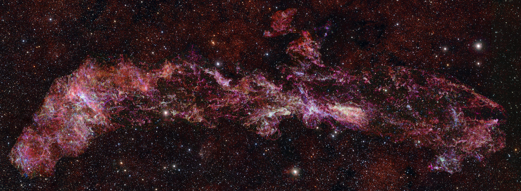 This image provided by the European Southern Observatory shows the complex distribution of molecular gas in the Central Molecular Zone (CMZ) of the Milky Way, designated in different colors: sulphur monoxide (cyan), silicon monoxide (green), isocyanic acid (red), cyanoacetylene (blue), and carbon monosulphide (magenta). The stars in the foreground of this image were observed at infrared wavelengths (Y, Z and J filters). (ALMA(ESO/NAOJ/NRAO)/S. Longmore via AP)