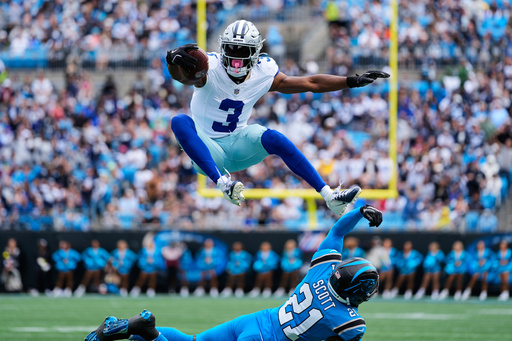 Dallas Cowboys wide receiver George Pickens (3) leaps over Carolina Panthers safety Nick Scott (21) after catching a pass in the first half of an NFL football game, Sunday, Oct. 12, 2025, in Charlotte, N.C. (AP Photo/Erik Verduzco) Dallas Cowboys wide receiver George Pickens (3) leaps over Carolina Panthers safety Nick Scott (21) after catching a pass in the first half of an NFL football game, Sunday, Oct. 12, 2025, in Charlotte, N.C. (AP Photo/Erik Verduzco)