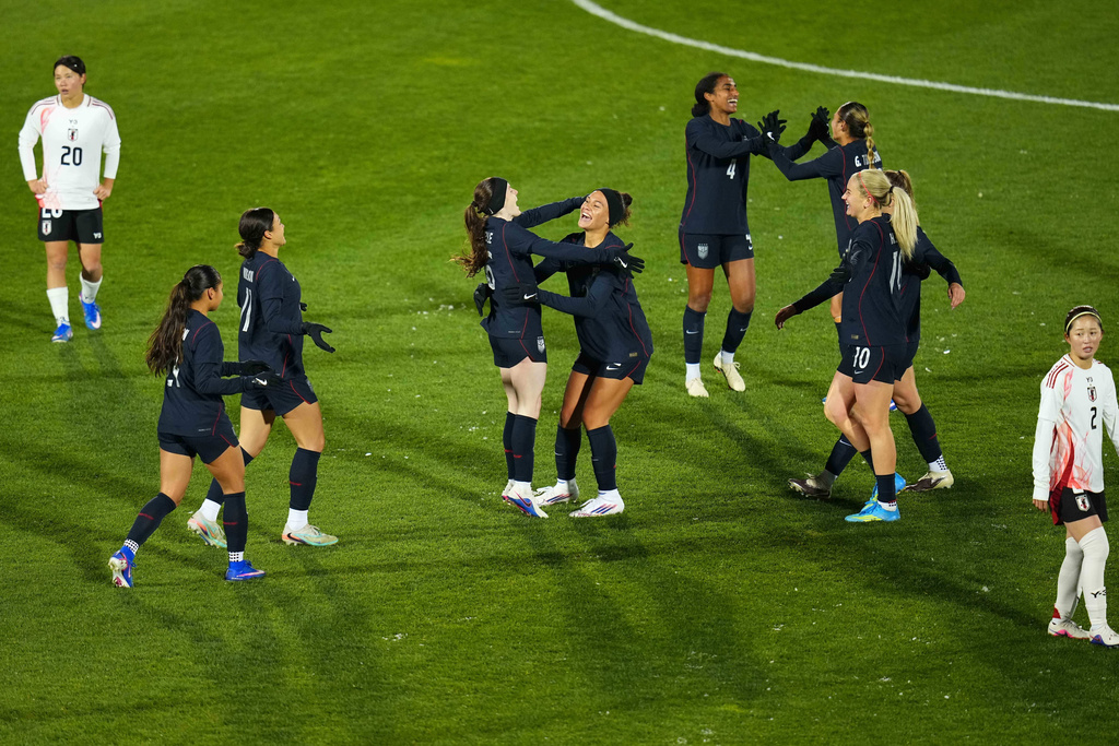 United States midfielder Rose Lavelle, center left, celebrates after a goal with teammate Trinity Rodman, center right, during the second half of an international friendly soccer match against Japan Friday, April 17, 2026, in Commerce City, Colo. (AP Photo/Jack Dempsey)