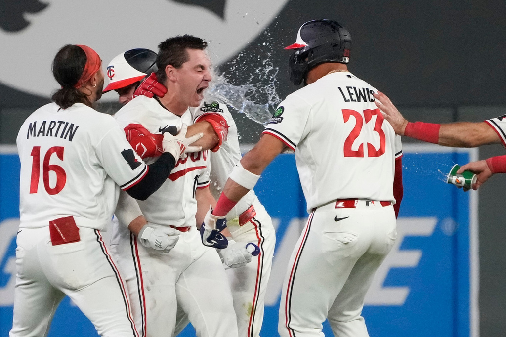 Minnesota Twins' Alan Roden, center left, celebrates with teammates after hitting a walk-off RBI single scoring Royce Lewis in the ninth inning of a baseball game against the Cleveland Guardians, Wednesday, July 8, 2026, in Minneapolis. (AP Photo/Joseph Scheller)
