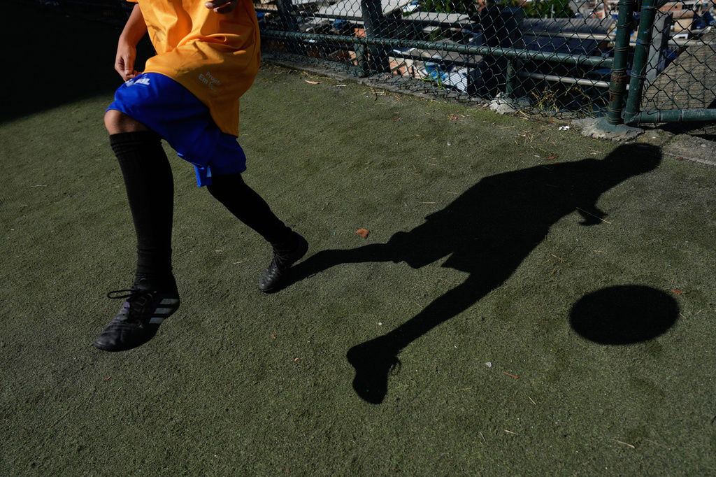 A youth attends a soccer training session by the Street Child United Brazil social project in the Complexo da Penha of Rio de Janeiro, Wednesday, June 3, 2026. (AP Photo/Silvia Izquierdo)