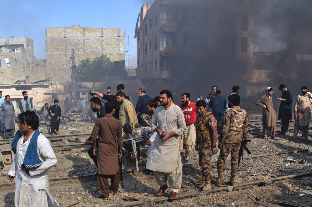 Paramilitary soldiers and volunteers transport an injured victim at the site of bomb explosion, in Quetta, Pakistan, Sunday, May 24, 2026. (AP Photo/Arshad Butt)