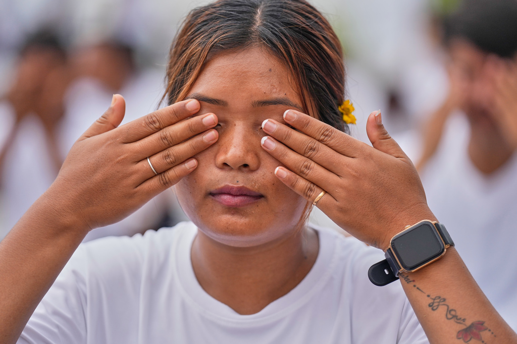 People perform yoga during an event to mark International Yoga Day along the river Brahmaputra in Guwahati, India, Sunday, June 21, 2026. (AP Photo/Anupam Nath)