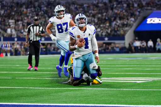 Dallas Cowboys quarterback Dak Prescott (4) is stopped as he carries the ball by Green Bay Packers defensive end Micah Parsons, rear, in overtime of an NFL football game Sunday, Sept. 28, 2025, in Arlington, Texas. (AP Photo/Jeffrey McWhorter) Dallas Cowboys quarterback Dak Prescott (4) is stopped as he carries the ball by Green Bay Packers defensive end Micah Parsons, rear, in overtime of an NFL football game Sunday, Sept. 28, 2025, in Arlington, Texas. (AP Photo/Jeffrey McWhorter)
