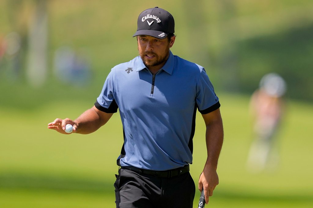 Xander Schauffele waves after his shot on the first green during the final round of the PGA Championship golf tournament at Aronimink Golf Club, Sunday, May 17, 2026, in Newtown Square, PA. (AP Photo/Matt Slocum)
