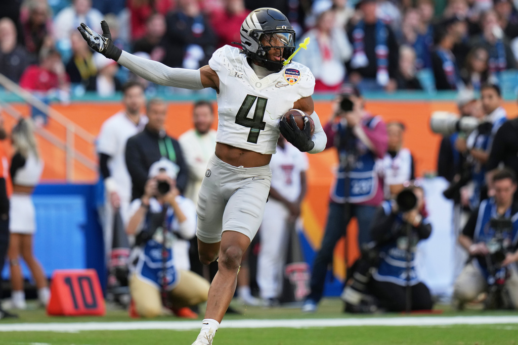 Oregon defensive back Brandon Finney (4) runs after intercepting the football during the first half of the Orange Bowl College Football Playoff quarterfinal game against Texas Tech, Thursday, Jan. 1, 2026, in Miami Gardens, Fla. (AP Photo/Lynne Sladky)