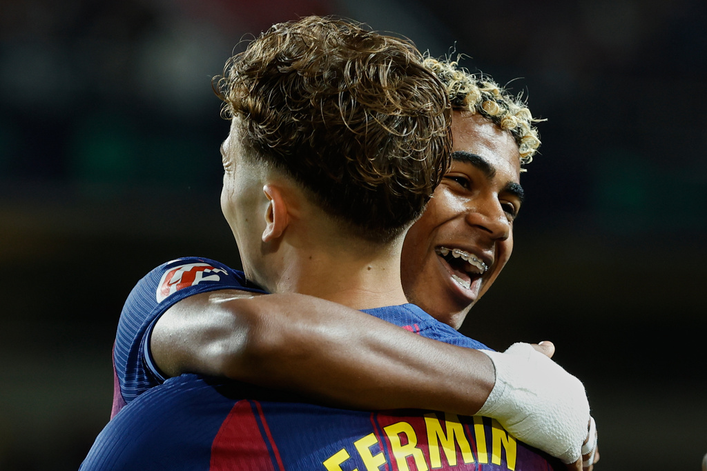 Barcelona's Lamine Yamal, right, celebrates with Barcelona's Fermin Lopez after their teammate Ferran Torres scored his side's second goal during a Spanish La Liga soccer match between FC Barcelona and Elche CF in Barcelona, Spain, Sunday, Nov. 2, 2025. (AP Photo/Joan Monfort)