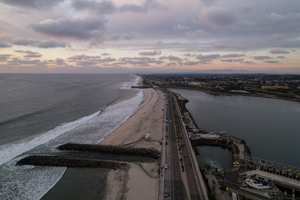 A drone view shows the Carlsbad desalination plant's intake lagoon on the right and the discharge canal on the left, Tuesday, Dec. 2, 2025, in Carlsbad, Calif. (AP Photo/Annika Hammerschlag)