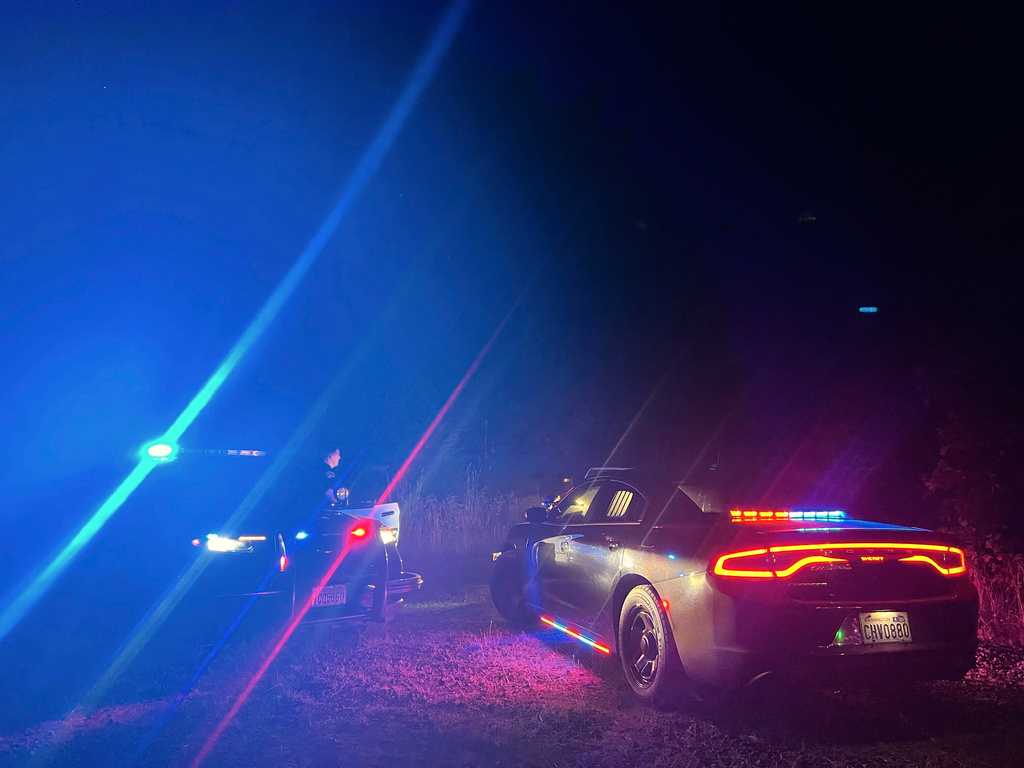 In this photo provided by the Thurston County Sheriff's Office, law enforcement personnel respond to a Wednesday evening, Sept. 17, 2025, helicopter crash near Joint Base Lewis-McChord in Washington state. (Thurston County Sheriff's Office via AP)