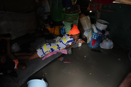 A woman lies inside a shack flooded by rain brought by Hurricane Melissa at a shelter for families displaced by gang violence in Port-au-Prince, Haiti, Wednesday, Oct. 29, 2025. (AP Photo/Odelyn Joseph) A woman lies inside a shack flooded by rain brought by Hurricane Melissa at a shelter for families displaced by gang violence in Port-au-Prince, Haiti, Wednesday, Oct. 29, 2025. (AP Photo/Odelyn Joseph)