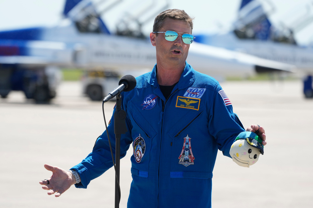 Artemis 2 Commander Reid Wiseman speaks to the media after the crew's arrival at the Kennedy Space Center, Friday, March 27, 2026, in Cape Canaveral, Fla. (AP Photo/Chris O'Meara)