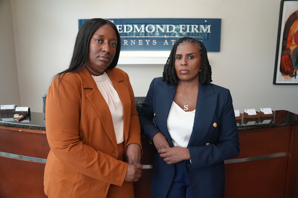 Cassandra Barksdale, left, who says she was wrongly diagnosed with cancer due to a tissue labelling mistake, poses with her lawyer Shannan Young in Atlanta, Ga., Thursday, Aug. 6, 2026. (AP Photo/Emilie Megnien)