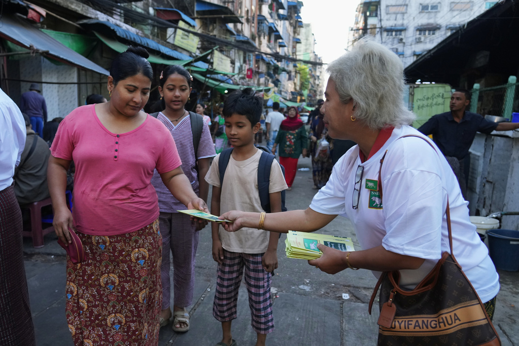 A member of the Shan and Nationalities Democratic Party (SNDP) distributes leaflets of their party during the last day of the first phase of their election campaign in Yangon, Myanmar, Friday, Dec. 26, 2025. (AP Photo/Thein Zaw)