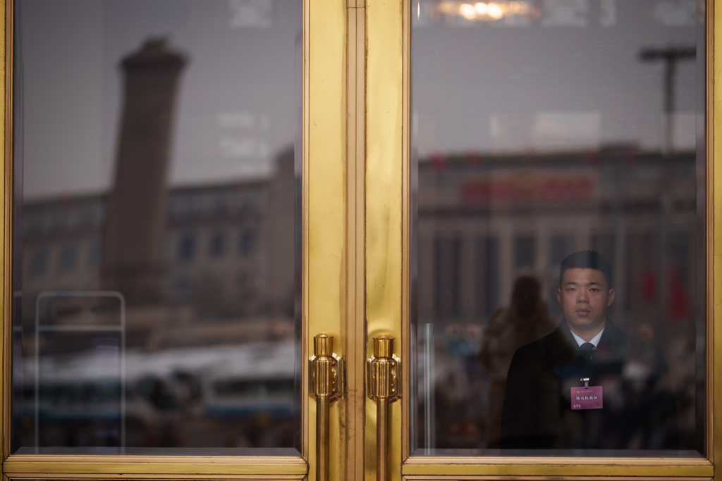A soldier dressed as an usher stands guard at an entrance door of the Great Hall of the People during the opening session of the National People's Congress (NPC) at the Great Hall of the People in Beijing, China, Thursday, March 5, 2026. (AP Photo/Vincent Thian)
