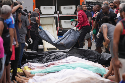 Forensic workers collect the bodies of people killed the day before during a police raid targeting the Comando Vermelho gang in the Complexo da Penha favela of Rio de Janeiro, Brazil, Wednesday, Oct. 29, 2025. (AP Photo/Silvia Izquierdo) Forensic workers collect the bodies of people killed the day before during a police raid targeting the Comando Vermelho gang in the Complexo da Penha favela of Rio de Janeiro, Brazil, Wednesday, Oct. 29, 2025. (AP Photo/Silvia Izquierdo)