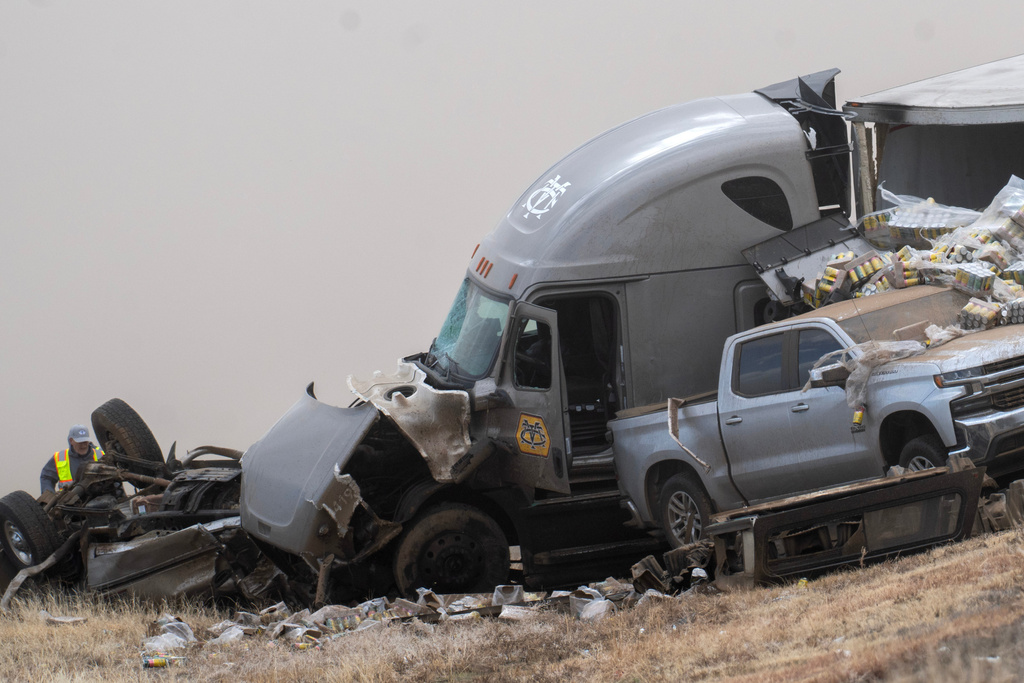 Emergency personnel work the scene of a crash involving 30-plus vehicles including six semi trucks on Interstate 25 south of Pueblo, Colo., on Tuesday, Feb. 17, 2026. (Christian Murdock/The Gazette via AP)