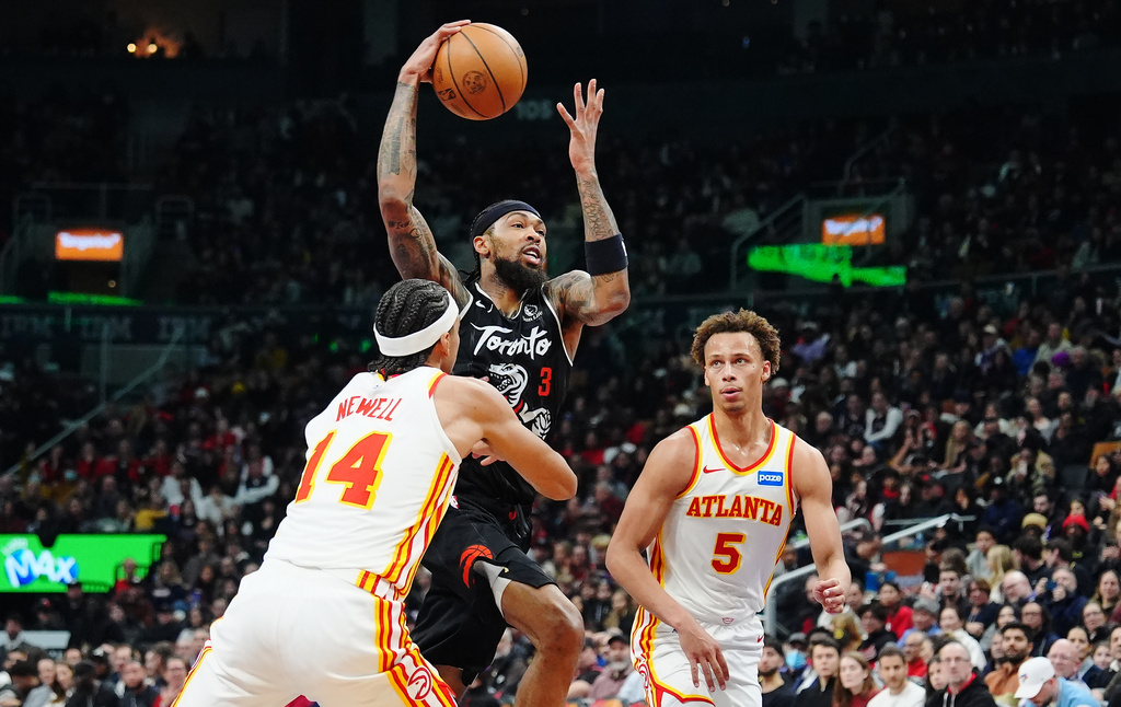 Toronto Raptors' Brandon Ingram (3) drives between Atlanta Hawks' Asa Newell (14) and Dyson Daniels (5) during the first half of an NBA basketball game in Toronto on Saturday, Jan. 3, 2026. (Frank Gunn/The Canadian Press via AP)