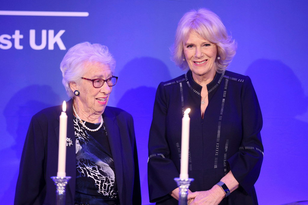 FILE - Britain's Camilla, Duchess of Cornwall, right, and Eva Schloss, step-sister of Anne Frank and Honorary President of the Anne Frank Trust UK, take part in a candle lighting ceremony during a reception for the Anne Frank Trust in London, Thursday Jan. 20, 2022. (Chris Jackson/Pool via AP, file)
