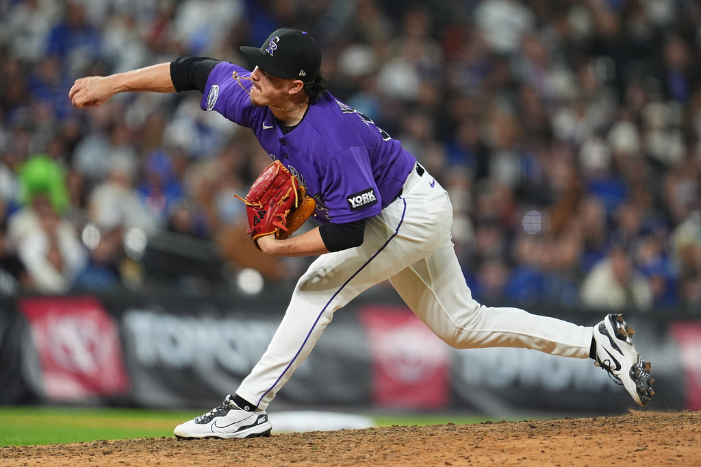 Colorado Rockies relief pitcher Victor Vodnik works against the Los Angeles Dodgers in the ninth inning of a baseball game Saturday, April 18, 2026, in Denver. (AP Photo/David Zalubowski)