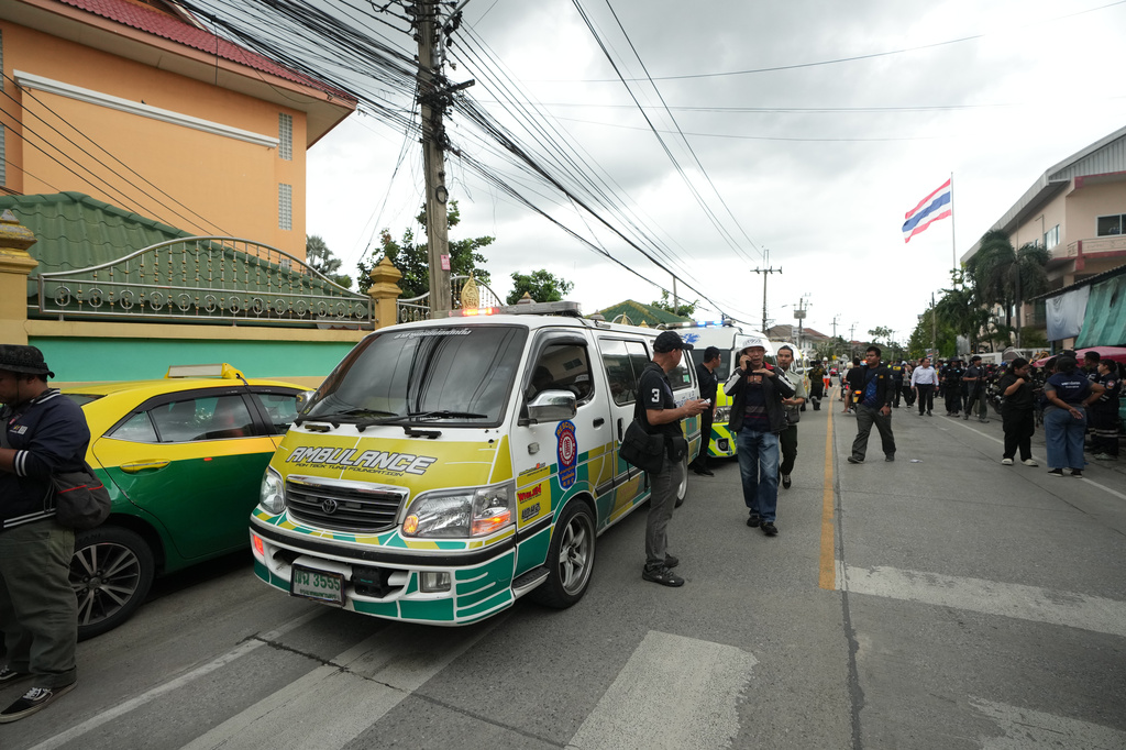 A crowd gathers outside a school where deaths and injuries were reported after a shooting in Thailand's Nonthaburi province, Friday, Aug. 7, 2026. (AP Photo/Sakchai Lalit)