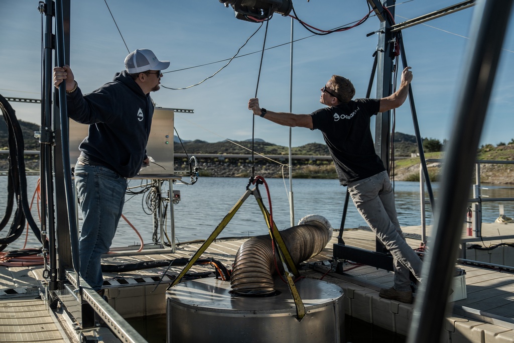 Jaden Gilliam, OceanWell project engineer, left, and Mark Golay, director of engineering projects, lower a prototype reverse osmosis pod into Las Virgenes Reservoir in Westlake Village, Calif., Monday, Dec. 1, 2025. (AP Photo/Annika Hammerschlag)