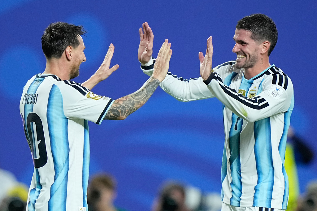 Argentina's Lionel Messi, left, celebrates with teammate Rodrigo de Paul after scoring his third goal during the World Cup Group J soccer match between Argentina and Algeria in Kansas City, Mo., Tuesday, June 16, 2026. (AP Photo/Charlie Riedel)